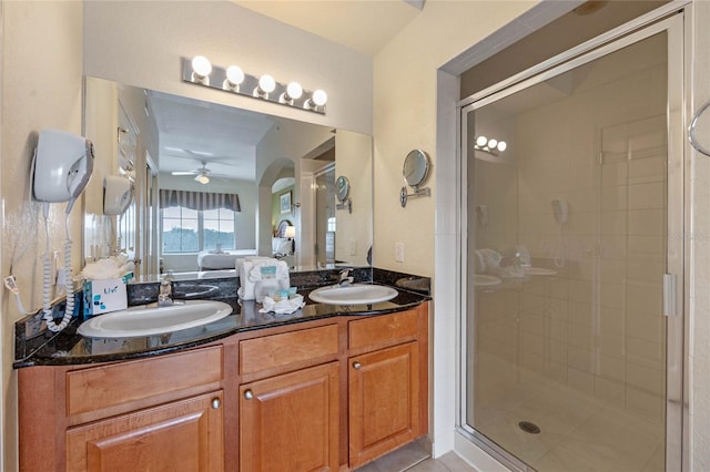 bathroom with walk in shower, vanity, tile patterned floors, and ceiling fan