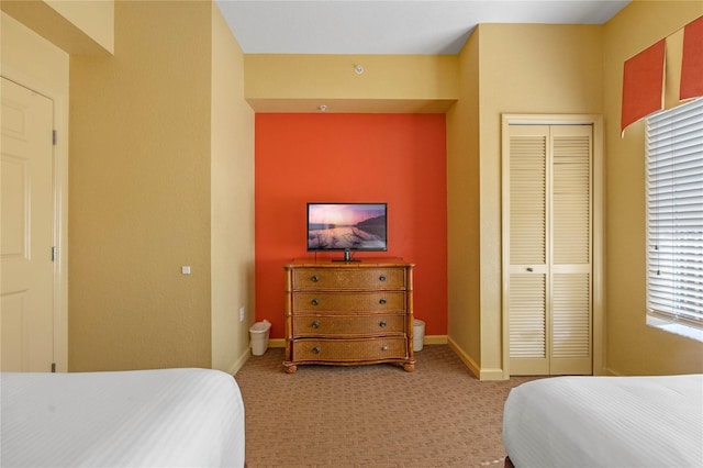 carpeted bedroom with a closet