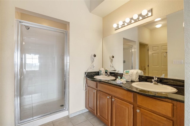 bathroom featuring tile patterned flooring, vanity, and a shower with door