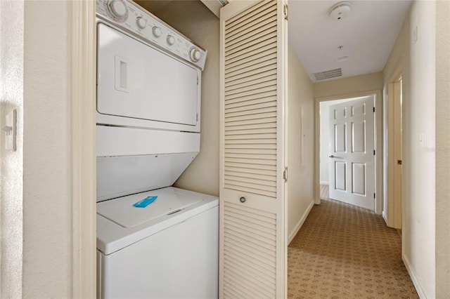 laundry room with stacked washer and dryer