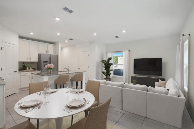 dining area with light tile patterned floors and sink