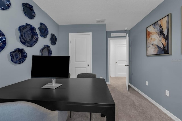 office space with light carpet and a textured ceiling