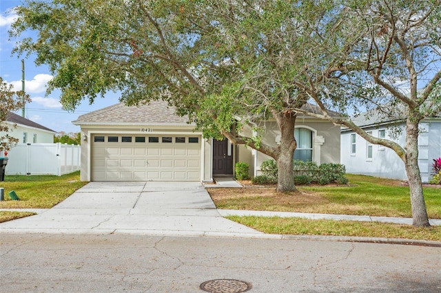 view of front of property featuring a garage and a front yard