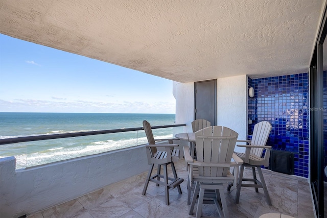 balcony with a view of the beach and a water view