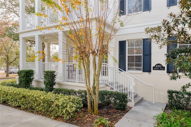 view of exterior entry featuring covered porch