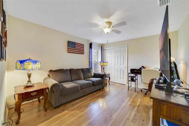 living room with ceiling fan and light wood-type flooring