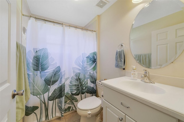 bathroom with vanity, tile patterned floors, and toilet