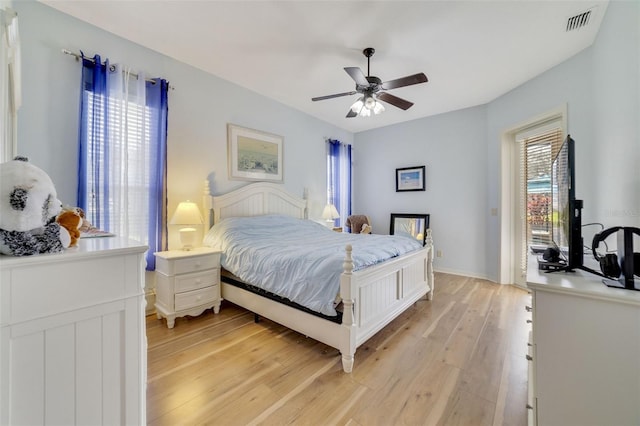 bedroom with multiple windows, access to outside, light hardwood / wood-style floors, and ceiling fan