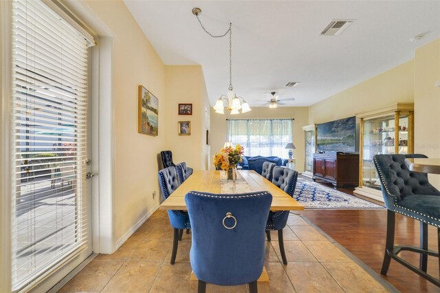 dining room featuring light tile patterned floors and an inviting chandelier