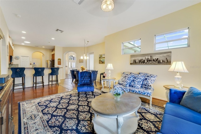 living room featuring wood-type flooring and ceiling fan