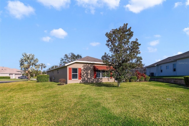 exterior space featuring a yard and glass enclosure