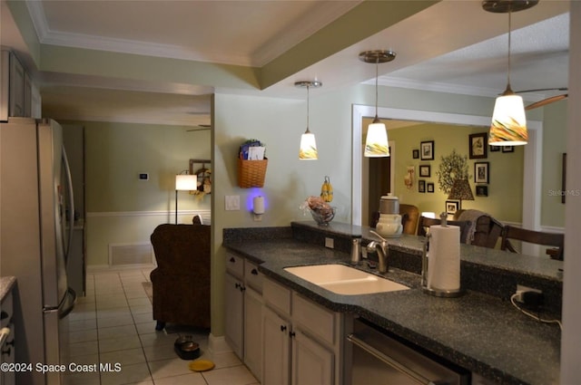 kitchen with crown molding, sink, decorative light fixtures, white fridge, and light tile patterned flooring