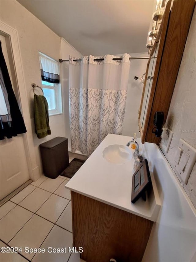 bathroom featuring tile patterned flooring and vanity