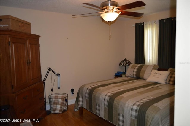 bedroom with wood-type flooring and ceiling fan