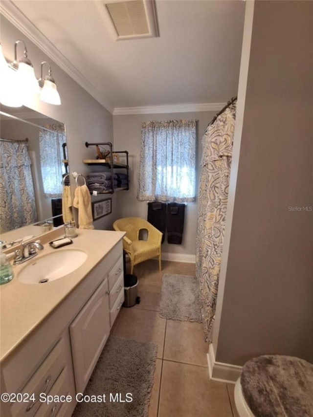 bathroom featuring vanity, tile patterned floors, and crown molding