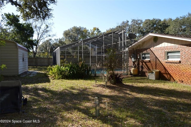 view of yard featuring glass enclosure and a pool