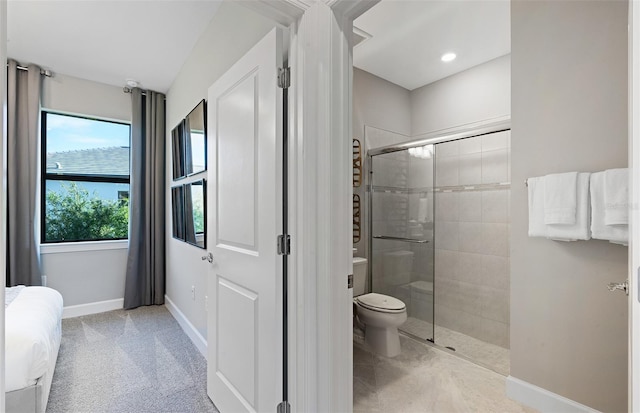 bathroom featuring toilet and an enclosed shower