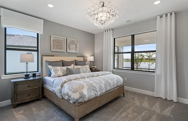 carpeted bedroom with a chandelier and multiple windows