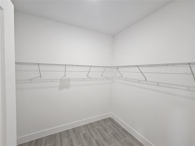 walk in closet with wood tiled floor