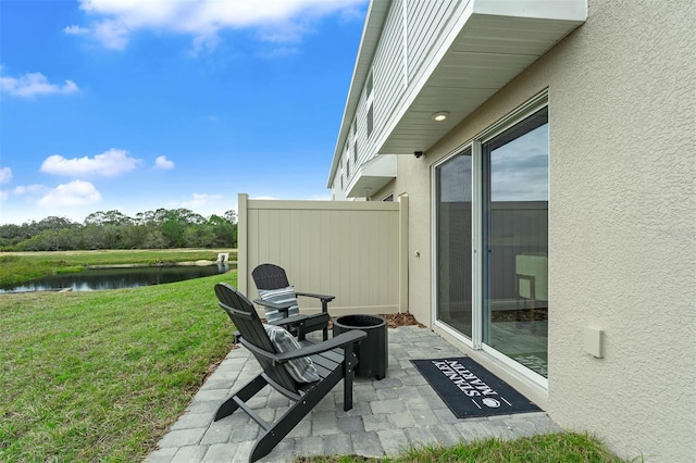 view of patio with a water view