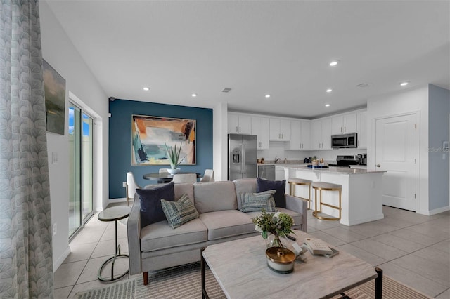 living room featuring light tile patterned floors and sink