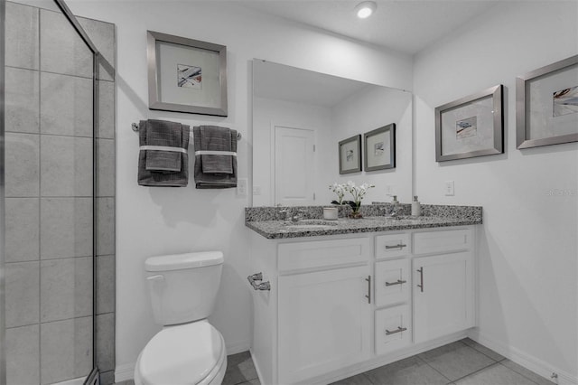 bathroom with vanity, tile patterned floors, and toilet