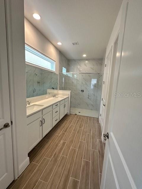 bathroom featuring an enclosed shower and vanity