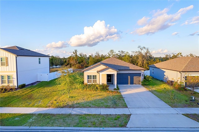 view of front facade with a front yard and a garage