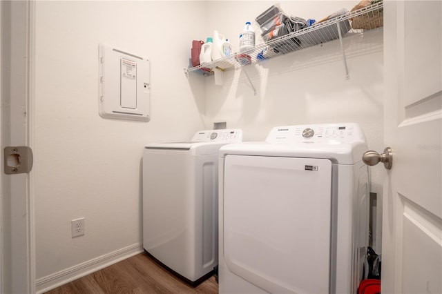 laundry room featuring washing machine and dryer, dark hardwood / wood-style floors, and electric panel