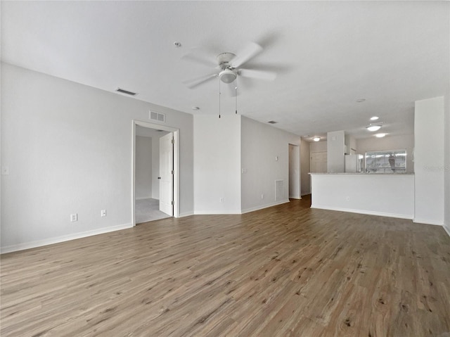 unfurnished living room with hardwood / wood-style floors and ceiling fan