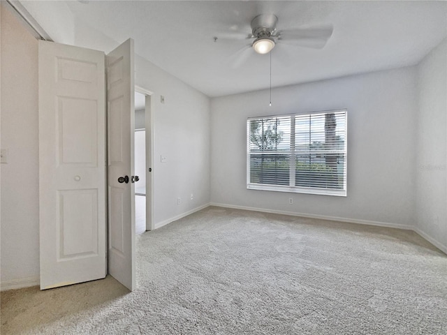 empty room with light carpet and ceiling fan