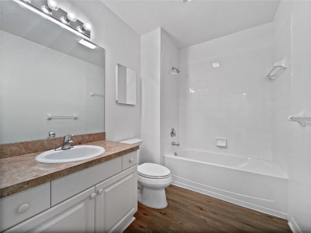 full bathroom featuring vanity, toilet, tiled shower / bath, and hardwood / wood-style flooring