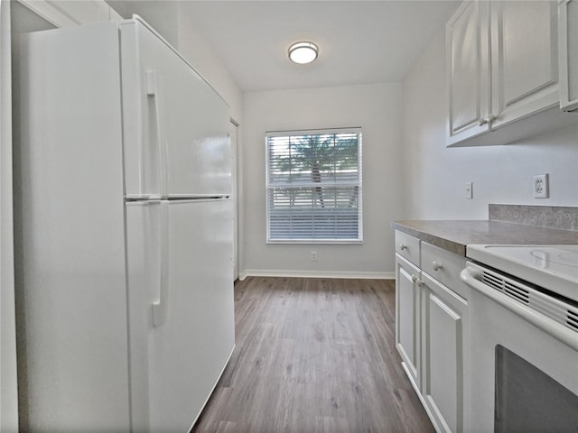 kitchen featuring white cabinets, white appliances, and light hardwood / wood-style flooring