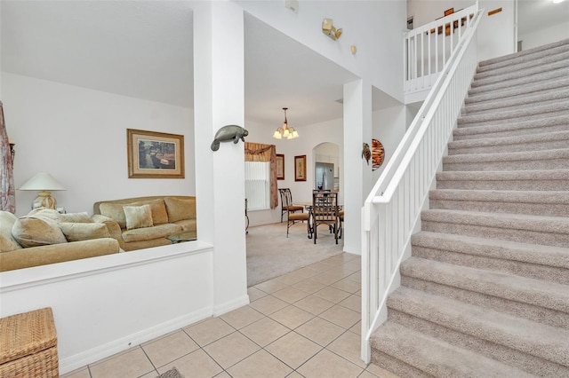 living room with light tile patterned floors and a notable chandelier