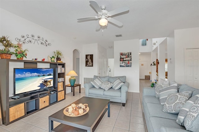 living room with light tile patterned floors and ceiling fan