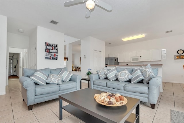 living room featuring light tile patterned floors and ceiling fan