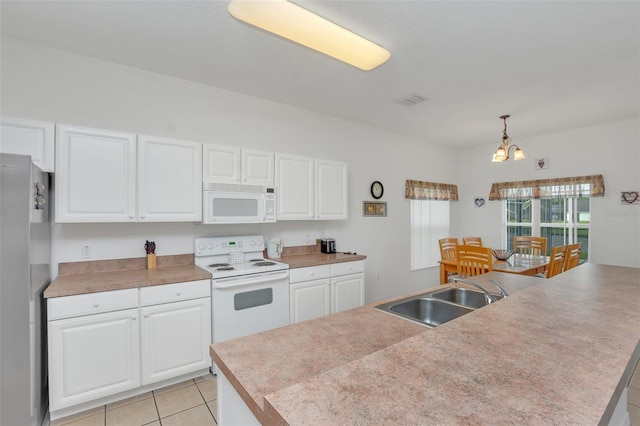 kitchen featuring white cabinetry, sink, decorative light fixtures, and white appliances