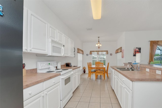 kitchen with white cabinetry, decorative light fixtures, a healthy amount of sunlight, and white appliances