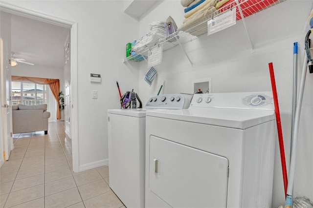 laundry area with washer and dryer, ceiling fan, and light tile patterned floors