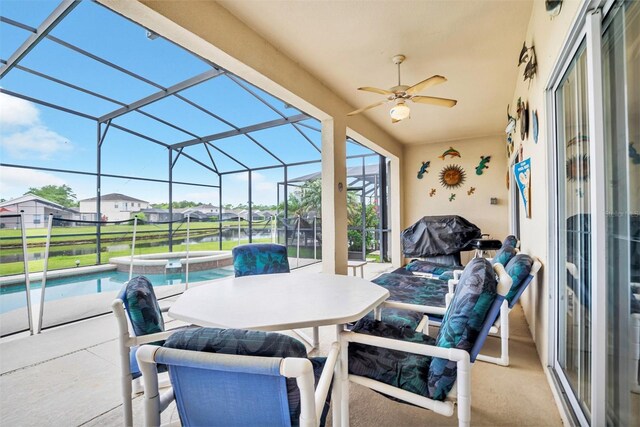 view of patio with ceiling fan, a pool with hot tub, and a lanai