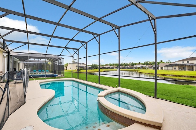 view of pool with an in ground hot tub, a water view, glass enclosure, and a lawn