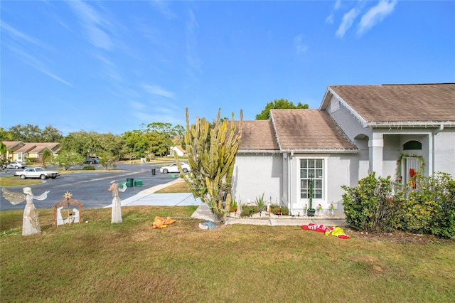 view of property exterior with a yard