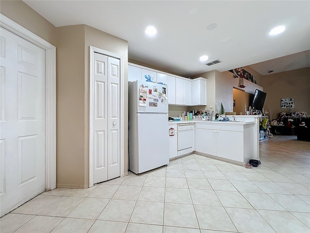 kitchen with white cabinetry, sink, kitchen peninsula, white appliances, and light tile patterned flooring