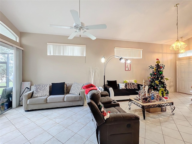 living room with light tile patterned floors and ceiling fan with notable chandelier