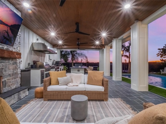 patio terrace at dusk with a grill and area for grilling