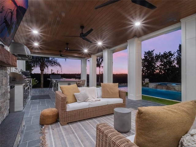 patio terrace at dusk with exterior kitchen