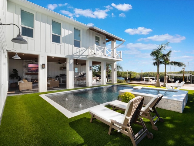 back of property featuring a yard, a patio area, a balcony, and an outdoor hangout area