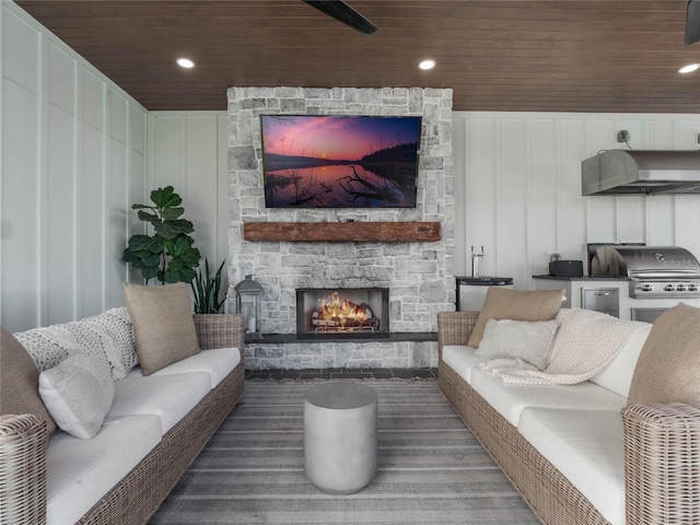 living room with a fireplace and wooden ceiling