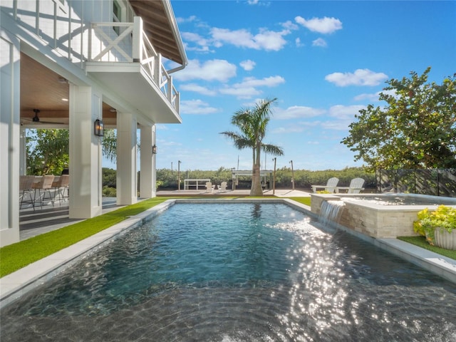 view of swimming pool with a patio area, pool water feature, and a jacuzzi