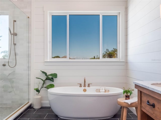 bathroom featuring wood walls, plus walk in shower, and a healthy amount of sunlight